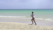 Woman jogging on beautiful beach, super slow motion