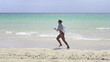 Woman jogging on beautiful topical beach