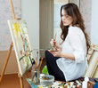  artist paints the house on canvas