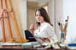  girl paints on canvas with oil colors