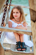 Lovely girl on bench in the beach resort