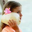 Lovely girl with shell at the beach