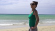 Happy woman standing on the beach