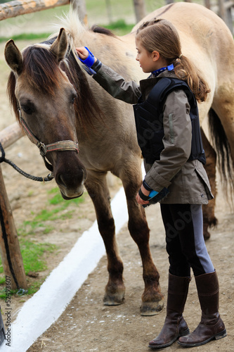 Photo: Horse and lovely equestrian girl, care for a horse Horse and lovely equestrian girl, care for a horse