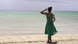 Woman in dress relaxing on beautiful beach
