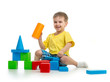 happy kid playing with colorful building blocks on white backgro