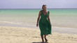 Woman in dress walking on the beach, super slow motion