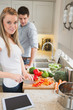 Couple in the kitchen with tablet computer