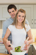 Man and woman preparing a salad
