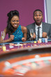 Photo: Couple sitting at roulette table waiting anxiously Couple sitting at roulette table waiting anxiously