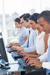 Call center employees sitting in line
