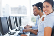 Smiling call center employee looking at camera