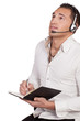 Man wearing a headset taking notes