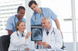 Smiling medical team examining radiography