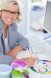 Cheerful interior designer looking at colour charts