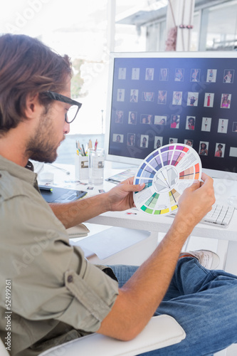 Photo: Editor looking at colour wheel Editor looking at colour wheel