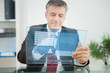 Businessman using futuristic touchscreen to view social network