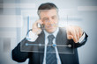 Businessman using futuristic touchscreen to view graph