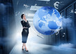 Businesswoman standing in data center with earth and currency gr