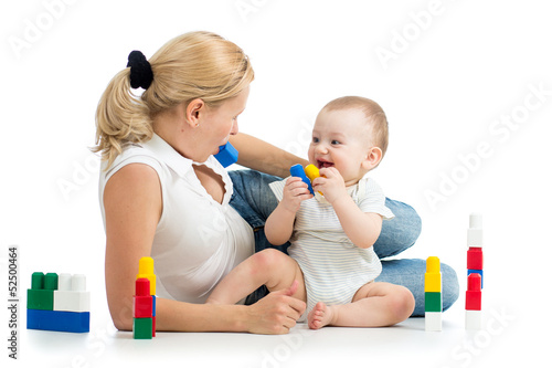 Photo: baby boy and mother playing together with construction set toy baby boy and mother playing together with construction set toy