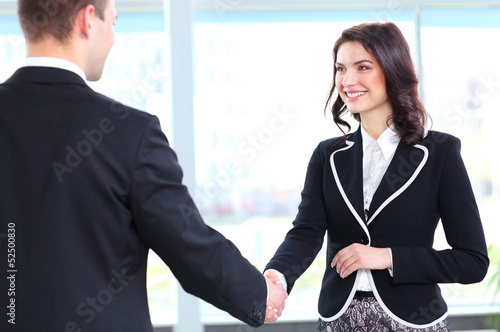 Photo: Business people shaking hands, finishing up a meeting Business people shaking hands, finishing up a meeting