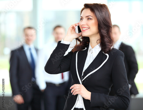 Photo: Beautiful business woman talking on cell phone Beautiful business woman talking on cell phone