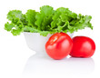 Bowl with fresh lettuce and two red tomatoes isolated on white b