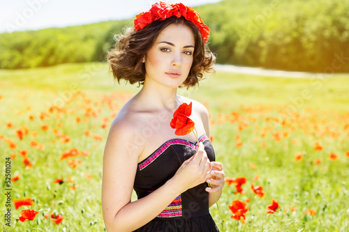 Photo: Young girl in poppies field Young girl in poppies field