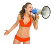 Angry young woman in swimsuit shouting through megaphone