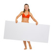Smiling young woman in swimsuit showing blank billboard