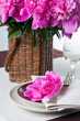 table setting with pink peonies, vintage cutlery and brown table