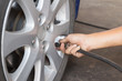 Man fill air into a car tire
