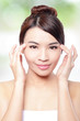 woman smile face and finger point to eyes