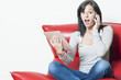 Woman with surprised expression while receiving a phone call