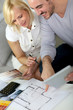 Photo: Couple working on home remodellng Couple working on home remodellng