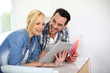 Middle-aged couple choosing wall colours for new home