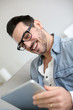 Foto: Middle-aged guy using digital tablet at home Middle-aged guy using digital tablet at home