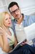 Couple reading news with horrified look