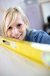 Closeup of blond woman using level