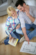 Photo: Couple looking at new home construction plan Couple looking at new home construction plan