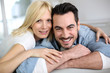 canvas print picture - Sweet middle-aged couple embracing in sofa