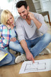 Photo: Couple looking at new home construction plan Couple looking at new home construction plan
