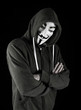 Hooded man wearing Vendetta mask
