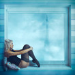 Sexy curly blonde sit on near window in corset