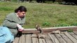 Guy feeding wild squirrels. Moonstone Beach, Cambria, California