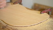 Luthier polishes wood for flamenco guitar