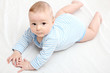 Baby boy lies on bed
