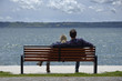Italy, Bracciano lake, young couple relaxing on a bench