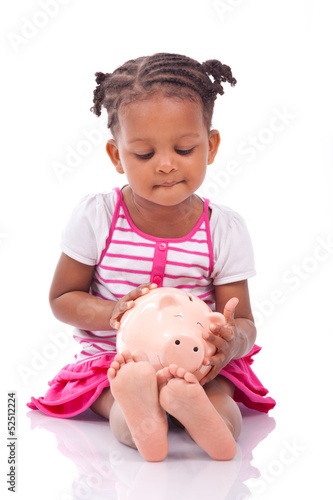 Photo: Cute little black girl holding a smiling piggy bank - African ch Cute little black girl holding a smiling piggy bank - African ch