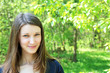 young beautiful girl on a background of green vegetation